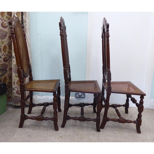 105 - A set of six early/mid 20thC oak framed traditional English style dining chairs with caned backs and... 