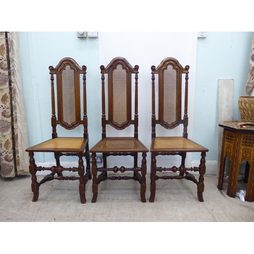 105 - A set of six early/mid 20thC oak framed traditional English style dining chairs with caned backs and... 