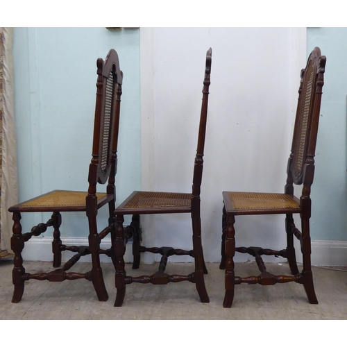 105 - A set of six early/mid 20thC oak framed traditional English style dining chairs with caned backs and... 