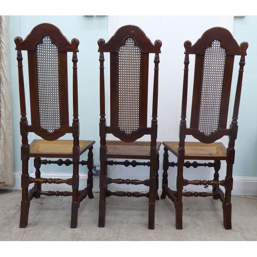 105 - A set of six early/mid 20thC oak framed traditional English style dining chairs with caned backs and... 