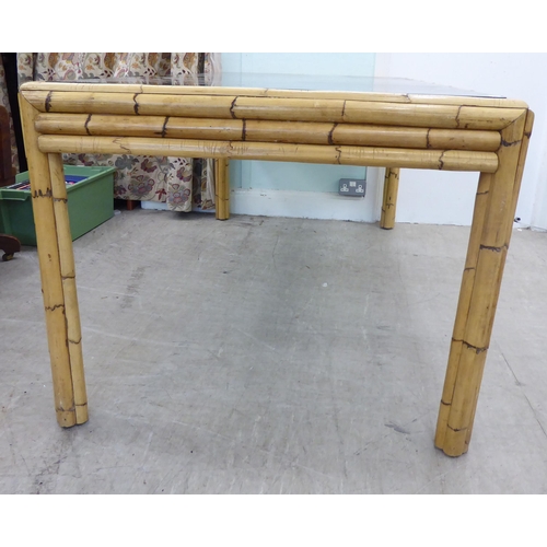 112 - A 1970s layered bamboo bound dining table with an inset tinted glass top  30