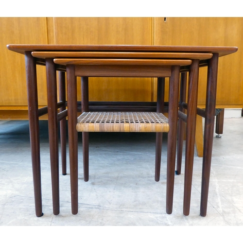 114 - A nesting set of three circa 1960s (probably Danish) teak occasional tables, raised on turned, taper... 