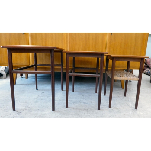 114 - A nesting set of three circa 1960s (probably Danish) teak occasional tables, raised on turned, taper... 