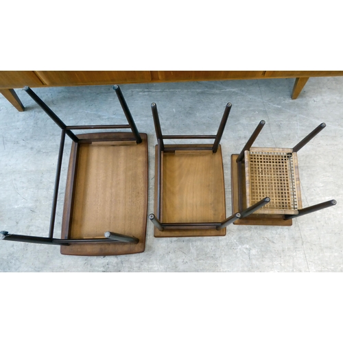 114 - A nesting set of three circa 1960s (probably Danish) teak occasional tables, raised on turned, taper... 