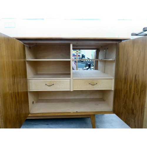 117 - A 1960/70s Produit Suisse Schweizerjabrikat teak sideboard with four doors, enclosing open shelves, ... 