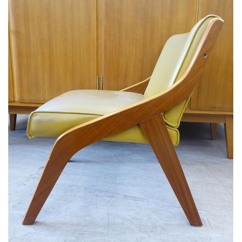 126 - A walnut framed and hide upholstered lounge chair by Neil Morris, raised on splayed legs