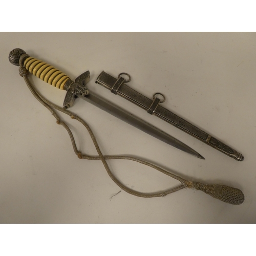 129 - A German World War II era Luftwaffe dagger with a wire bound celluloid grip, emblems and a knot, the... 