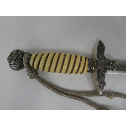 129 - A German World War II era Luftwaffe dagger with a wire bound celluloid grip, emblems and a knot, the... 