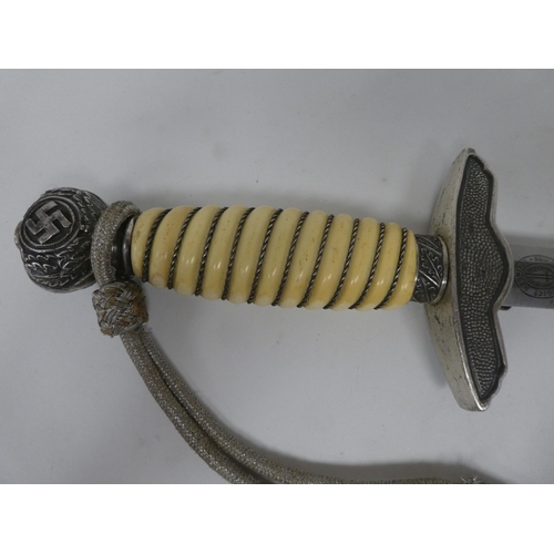 129 - A German World War II era Luftwaffe dagger with a wire bound celluloid grip, emblems and a knot, the... 