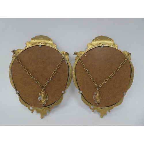 133 - A pair of modern mirrors, set in elaborately, scroll, shell and cherubic figure moulded gilt frames&... 