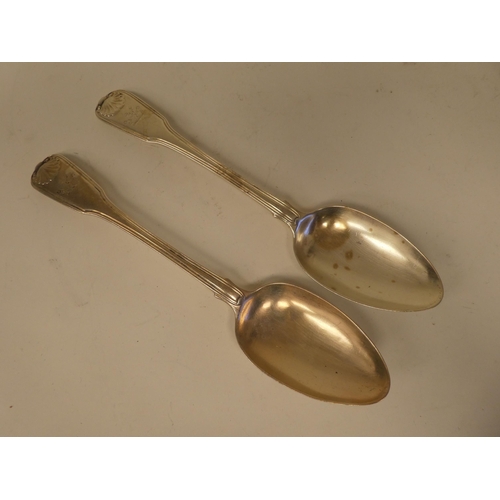 135 - A pair of George III silver fiddle and shell pattern table spoons  William Eley & William Fearn ... 