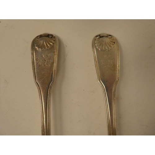 135 - A pair of George III silver fiddle and shell pattern table spoons  William Eley & William Fearn ... 