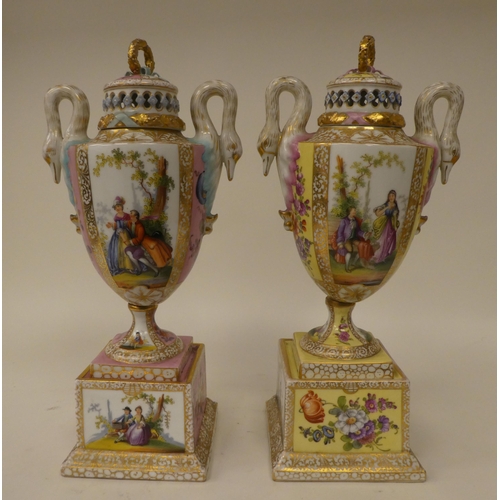 145 - A pair of Dresden porcelain, twin handled pedestal pot pourri vases, decorated in figural panels and... 