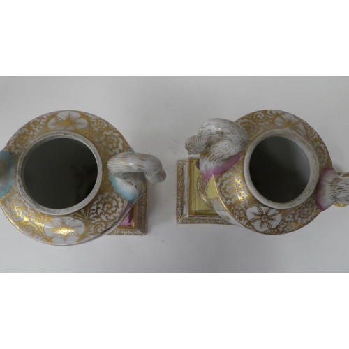 145 - A pair of Dresden porcelain, twin handled pedestal pot pourri vases, decorated in figural panels and... 