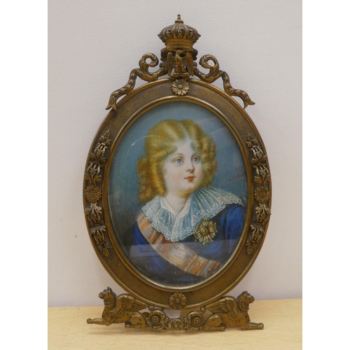 148 - An oval portrait miniature on ivory, depicting a head and shoulders study, a child, wearing a sash a... 