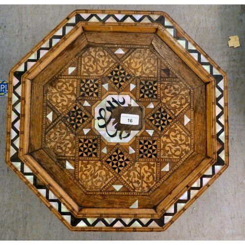 16 - An early 20thC Moroccan hardwood, octagonal table with intricately inlaid geometric ornament, highli... 