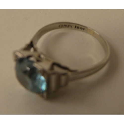 186 - Two dissimilar rings, set with aquamarine coloured stones