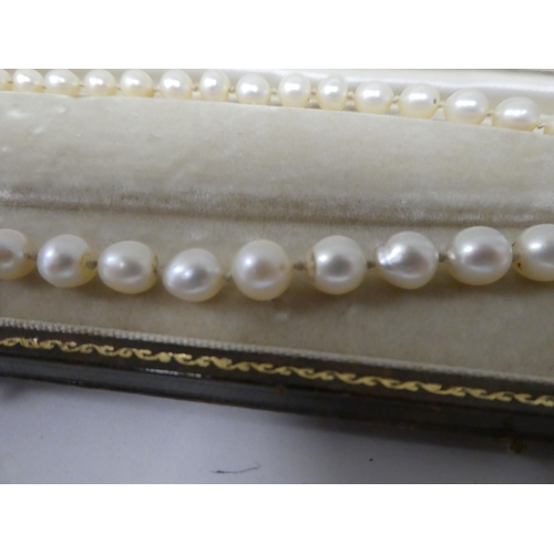 195 - A single strand graduated pearl necklace  boxed