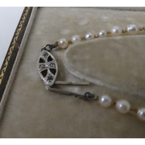 195 - A single strand graduated pearl necklace  boxed