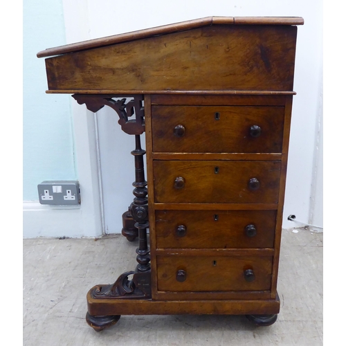 206 - A late Victorian crossbanded ebony and string inlaid, walnut finished Davenport with a hinged scribe... 