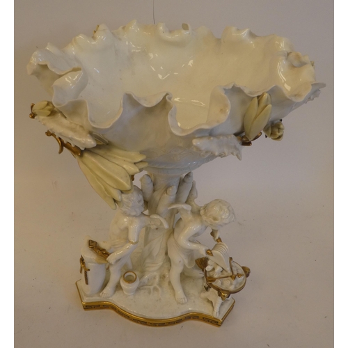 21 - A late 19thC Moore white pottery and part gilded table centrepiece, featuring a floral encrusted bow... 