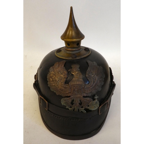 22 - A German pickelhaube with a chinstrap and brass plate(Please Note: this lot is subject to the statem... 