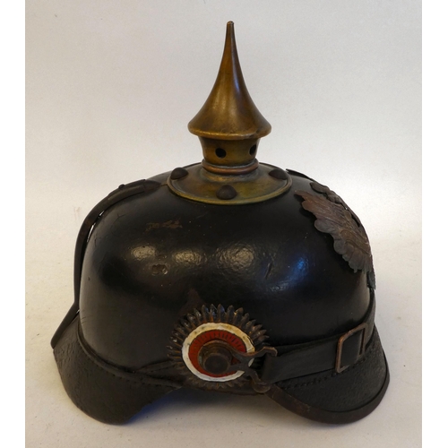 22 - A German pickelhaube with a chinstrap and brass plate(Please Note: this lot is subject to the statem... 