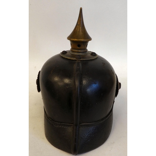 22 - A German pickelhaube with a chinstrap and brass plate(Please Note: this lot is subject to the statem... 