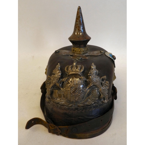 23 - A German pickelhaube with a chinstrap, white metal and brass fittings(Please Note: this lot is subje... 