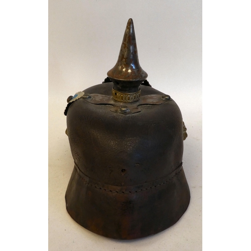 23 - A German pickelhaube with a chinstrap, white metal and brass fittings(Please Note: this lot is subje... 