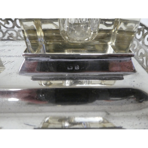 239 - A silver standish, the galleried tray with a pen channel and a pair of cast glass and silver lidded ... 