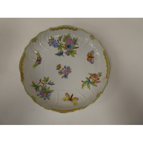 240 - A Herend porcelain shallow dish with a wavy, moulded basketweave border, decorated in colours with f... 