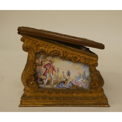 245 - A late 19thC Continental miniature timepiece (a/f), set in a rococo scrolled gilt metal and painted ... 