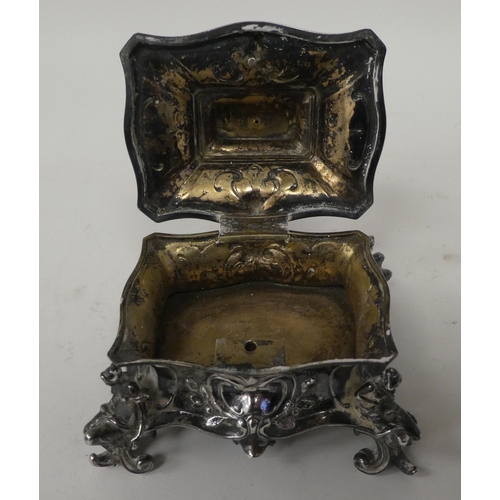 255 - A late 19thC Continental white metal jewellery casket, the hinged lid surmounted by a mother and chi... 