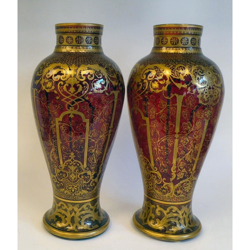 3 - A pair of late Victorian ruby glass vases of baluster form, densely decorated with gilt swags and fr... 