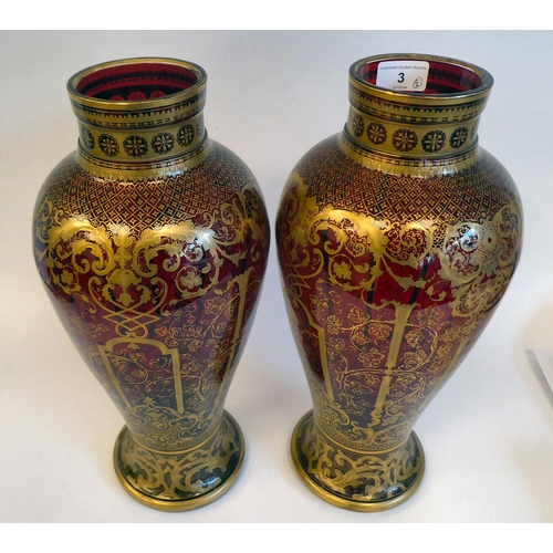 3 - A pair of late Victorian ruby glass vases of baluster form, densely decorated with gilt swags and fr... 