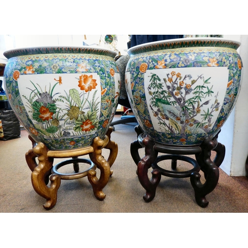 45 - A pair of 20thC Chinese porcelain fish bowls, decorated in colours and panels of flora and fish on t... 