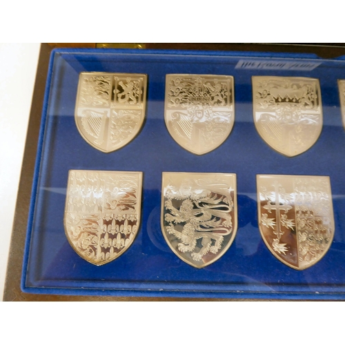 56 - A series of twelve silver coloured metal depictions of The Royal Arms, as borne by Queen Victoria th... 