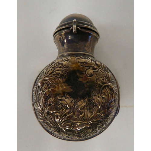 60 - A 19thC silver and parcel gilt, folding perfume bottle holder with embossed decoration, hinged acces... 