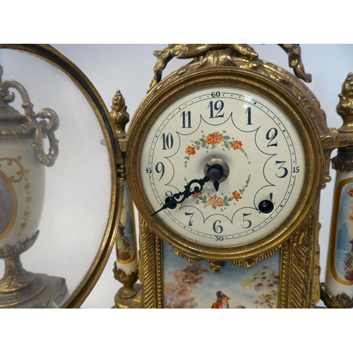 76 - A modern reproduction of a Victorian three piece clock garniture, the brass case with painted faux c... 