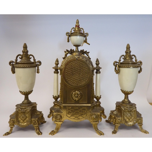 76 - A modern reproduction of a Victorian three piece clock garniture, the brass case with painted faux c... 