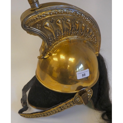 88 - A French Cuirassier brass officer's helmet with a red plume and hair tail(Please Note: this lot is s... 