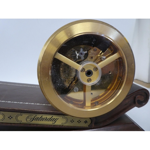 9 - A modern reproduction of 'The Inclined Plane Clock' featuring a gilt metal drum cased timepiece, on ... 