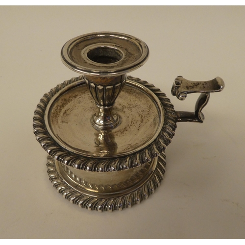 91 - An early Victorian silver taperstick holder with a vase shape socket and gadrooned ornament, set on ... 