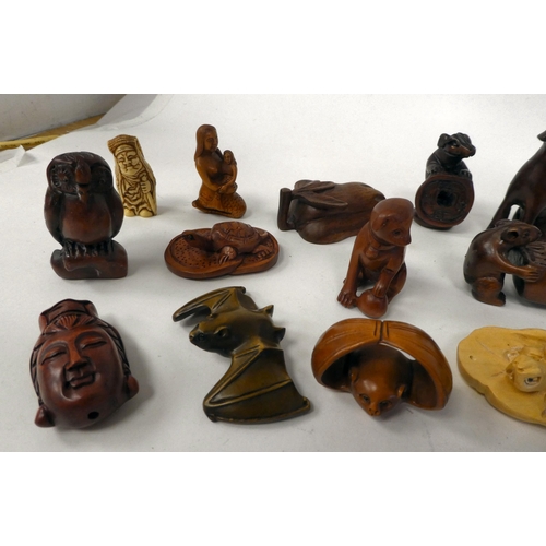 25 - Approx. twenty-five modern carved hardwood netsukes, in the form of various animals and figures