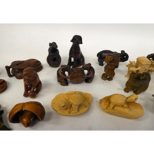 25 - Approx. twenty-five modern carved hardwood netsukes, in the form of various animals and figures