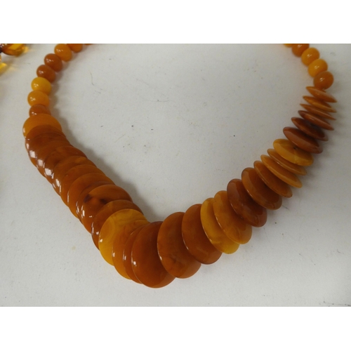 15 - Two graduated amber coloured bead necklaces