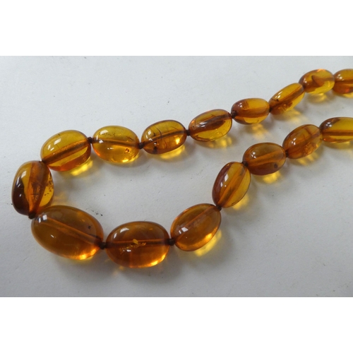 15 - Two graduated amber coloured bead necklaces