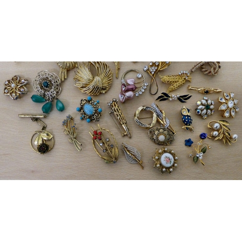 21 - Costume jewellery, mostly brooches: to include a floral example, set with simulated pearls