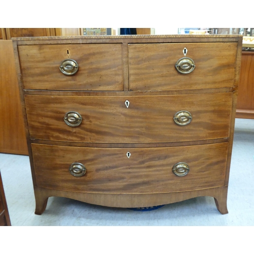 354 - An early 19thC mahogany bow front dressing chest with two short/two long drawers, raised on bracket ... 